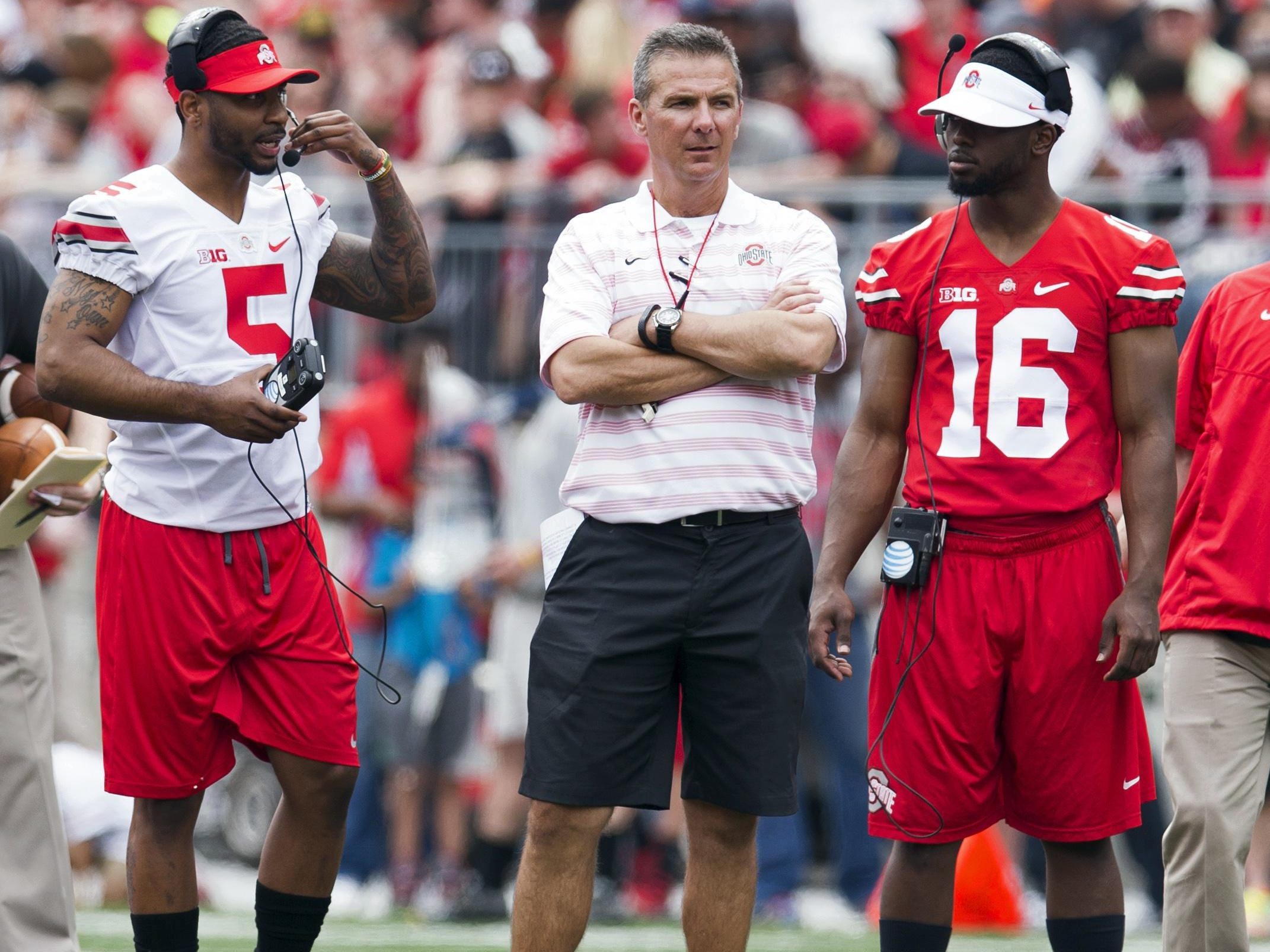 Ohio State coach Urban Meyer is flanked by Braxton Miller and J.T. Barrett at this year’s spring game. Miller is switching from quarterback to receiver after a second surgery on his throwing shoulder.