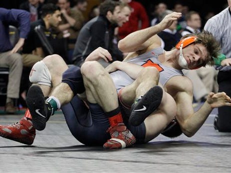 Illinois' Steven Rodrigues, top, competes with Nebraska's Austin Wilson in a semifinal at 165 pounds during the Big Ten wrestling championships in Iowa City, Iowa, on Saturday, March 5, 2016. (AP Photo/Matthew Holst)
