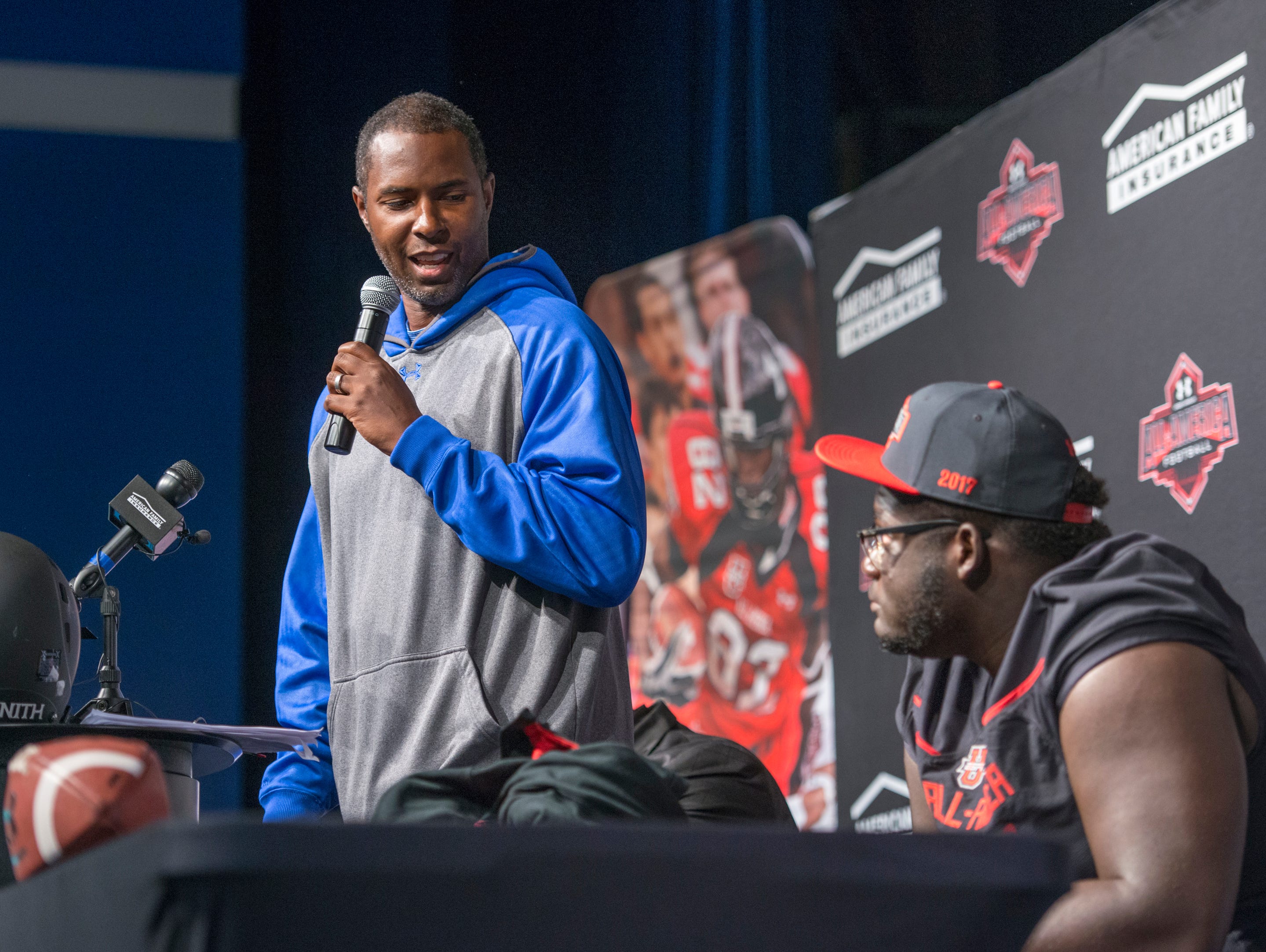 Coach Charlie Ward speaks during the event announcing that football player Alex Leatherwood, right, has been selected for the annual Under Armour High School All-America Game at Booker T. Washington High School in Pensacola on Wednesday, October 12, 2016. The game featuring more than 90 of the nation's best senior high school football players will be played on January 1, 2017.
