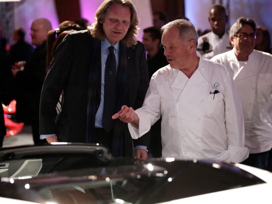 Celebrity chef Wolfgang Puck, center, chats with a