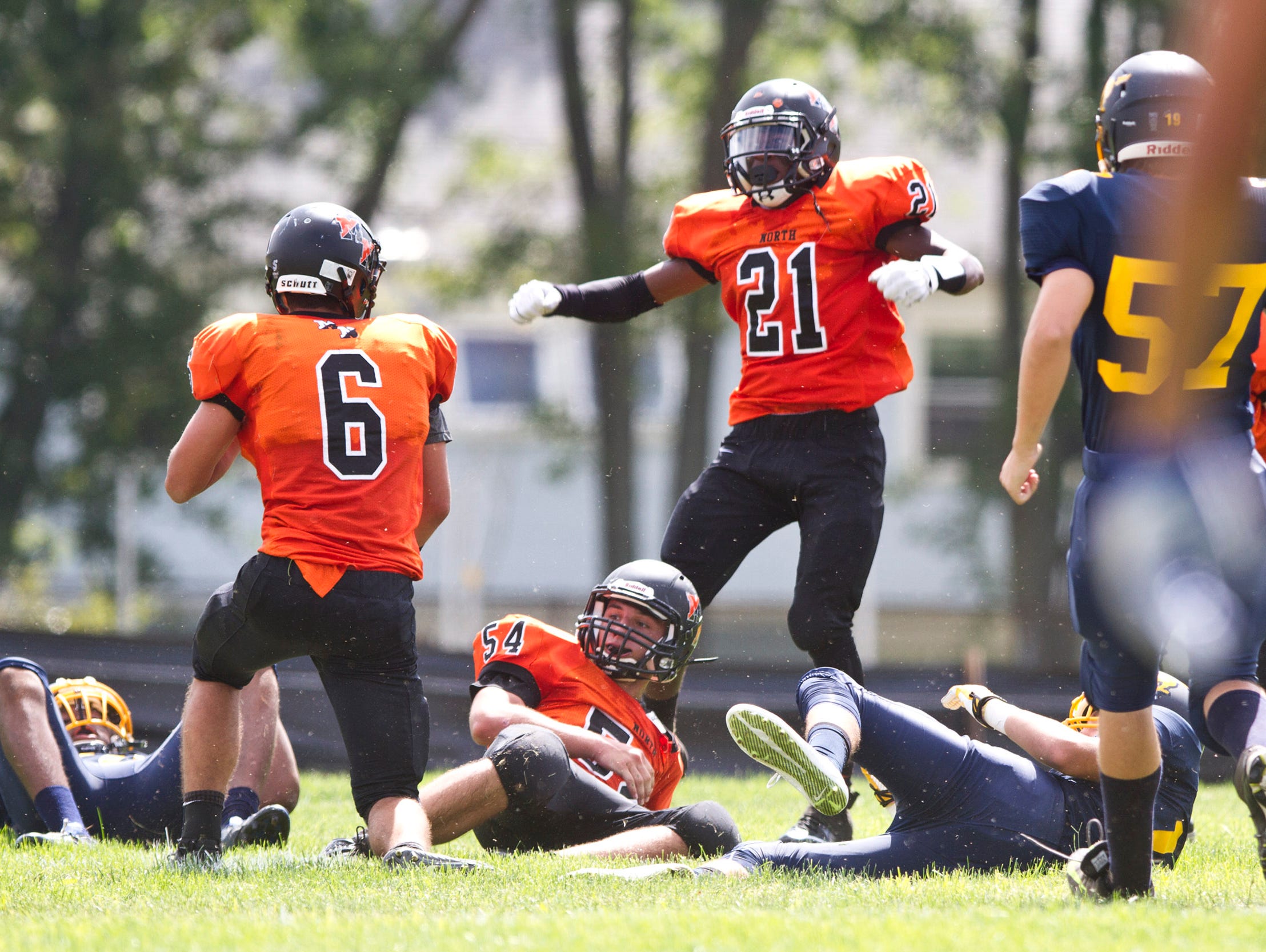 Middletown North's Josh Gomez (6) Jacob Dean (54) and Dwight Wilkerson (21) celebrate a touchdown after a blocked punt late in the second quarter. Middletown North vs Marlboro football. Marlboro, NJ Saturday, September 19, 2015 @dhoodhood