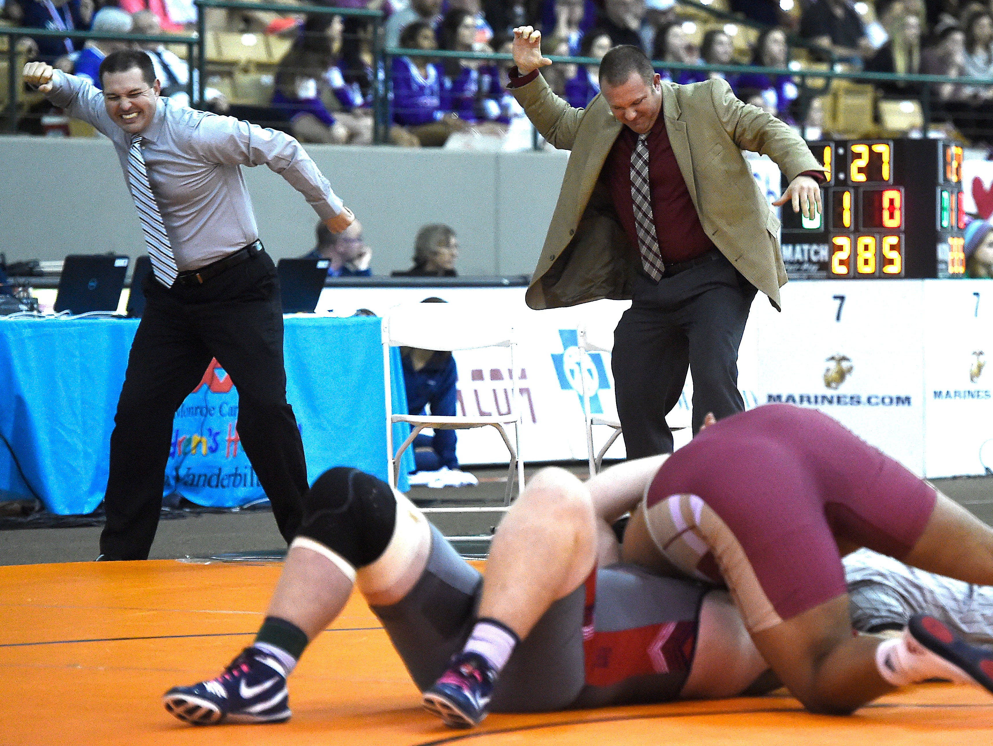 Riverdale coaches including Shawn Jones, right, celebrate before the pin is finished as they knew Nick Boykin (Riverdale) was going to defeat Logan Townsend (Jefferson Co.) at the TSSAA state wrestling championships Saturday Feb. 20, 2016, in Franklin, Tenn.