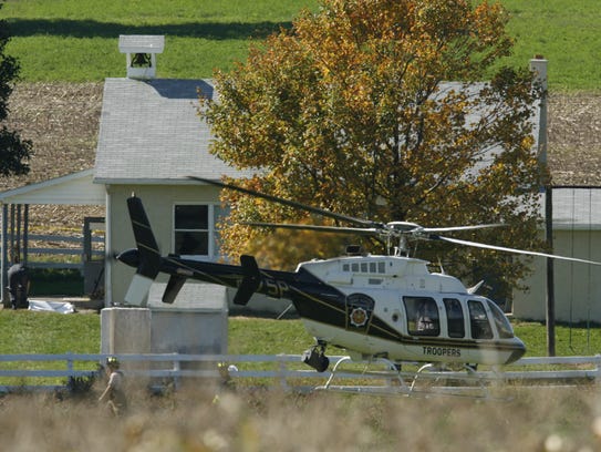 A police helicopter takes off from the scene of a school