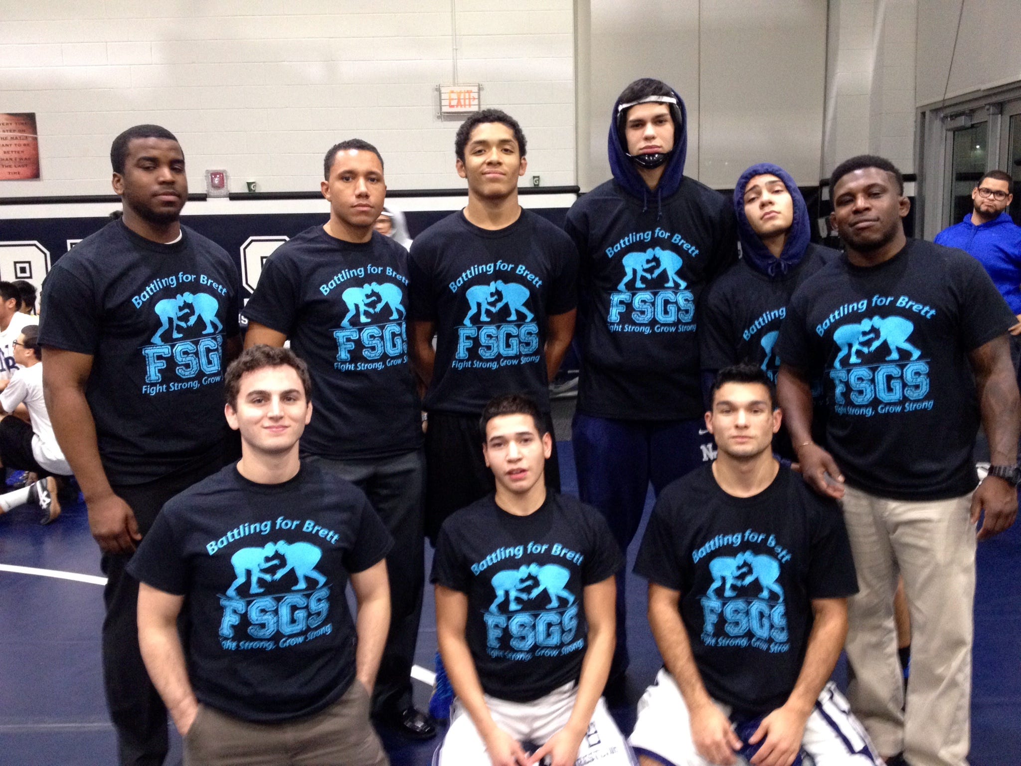 New Brunswick High School senior wrestlers and coaches show their support for former Rutgers Prep wrestling star Brett Epps by wearing “Battling for Brett” T-Shirts in honor of the Perth Amboy native, who is battling a rare kindey disease.