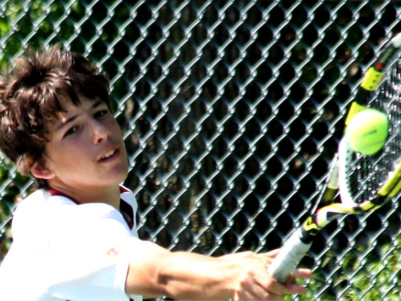 Turpin's Andrej Novakovic lunges to return a backhand against Walnut Hills in May of 2014.