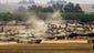Israeli soldiers stand near tanks positioned on the Israeli side of the border with the Gaza Strip on July 7.