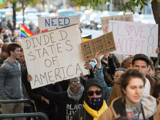 Demonstrators carry signs during a "Love Rally" in