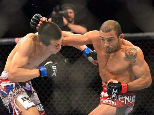 Jose Aldo (red gloves) fights Chan Sung Jung (blue gloves) during UFC ...
