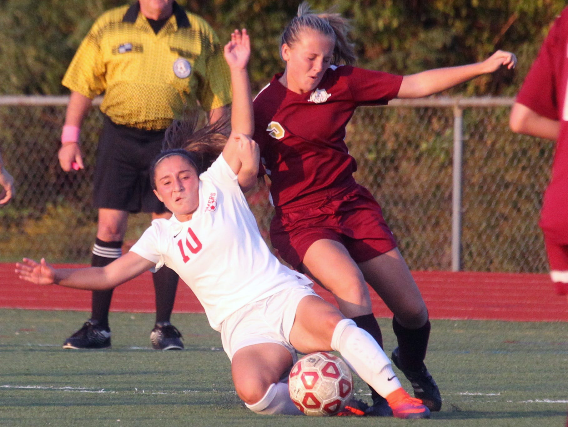 Somers' Jessica Rodriguez, left, is pressured by Arlington's Kendall Feighan during their game at Somers Oct. 17, 2016. Arlington won 2-1 in overtime.