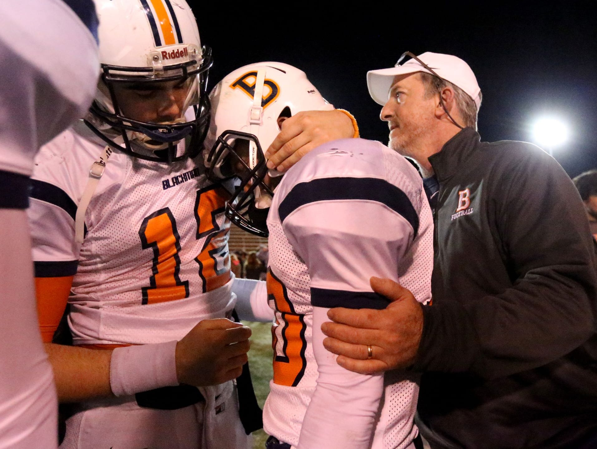 Blackman quarterback Miller Armstrong (12) comforts teammate Blake Taylor after Friday's loss at Maryville.