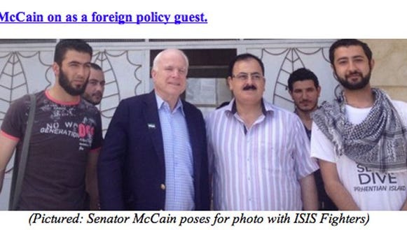 Who is McCain posing with?