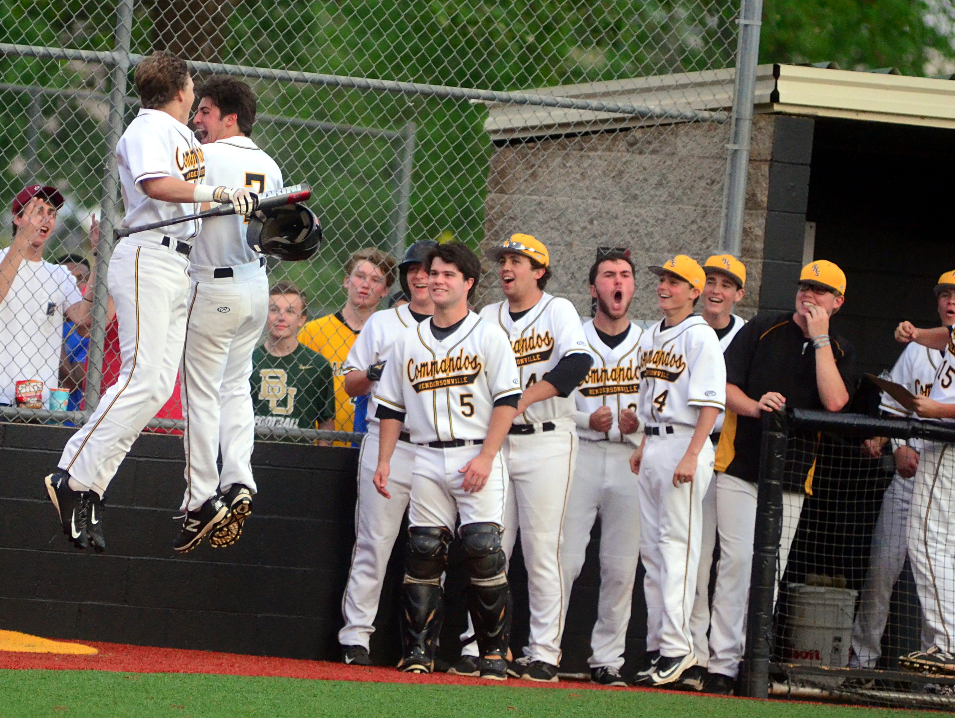 Hendersonville High senior Jon Swindle (7) and Commando teammates celebrate with sophomore Brett Coker (at left) after his first-inning home run on Tuesday evening.