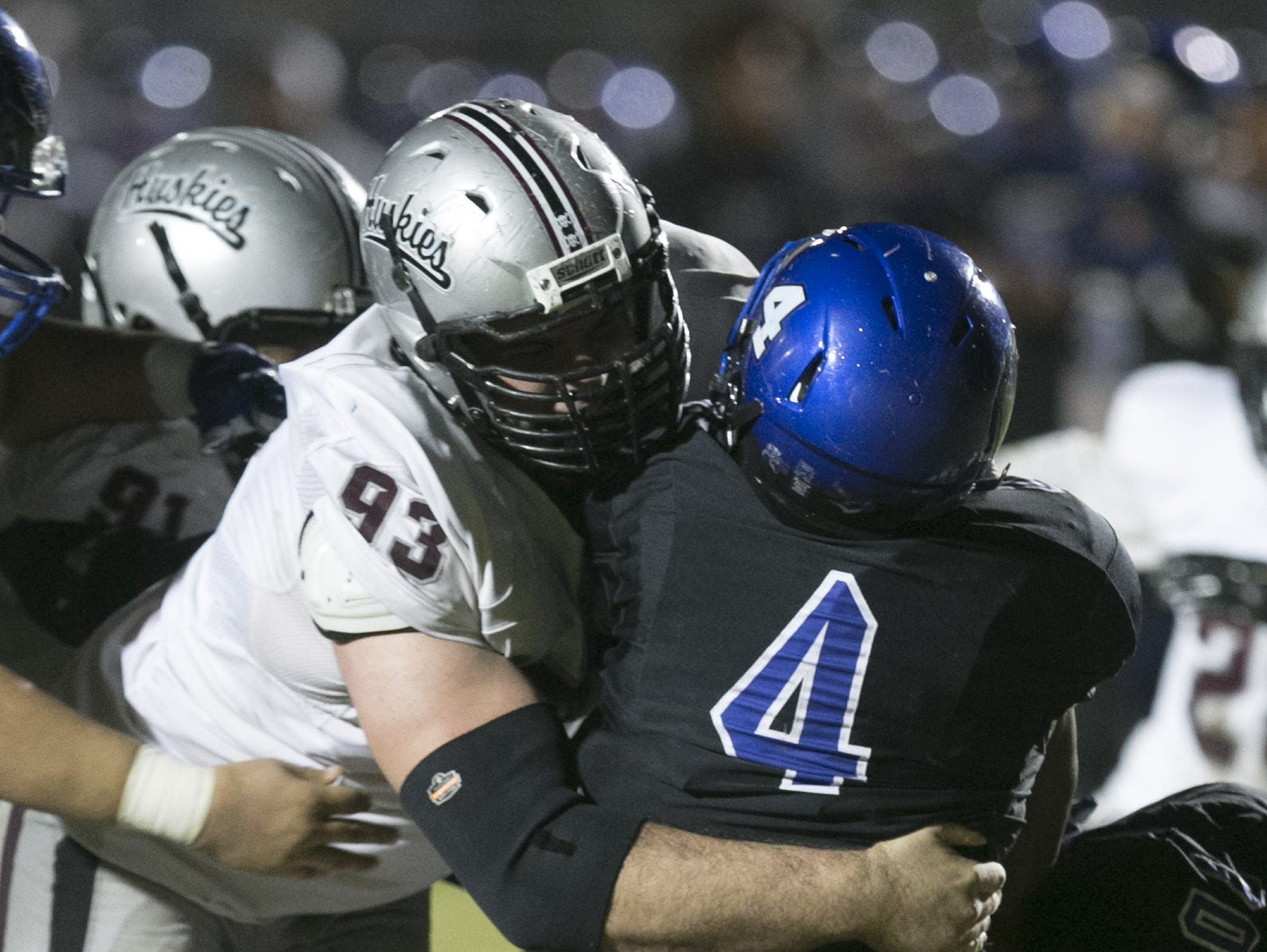 Hamilton High defensive lineman Garrett Rand tackles Chandler High's T.J. Green in the high school football game at Chandler High School in Chandler on Friday, Oct. 30, 2015.