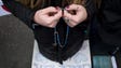 A pro-life activist holds rosary beads as she prays