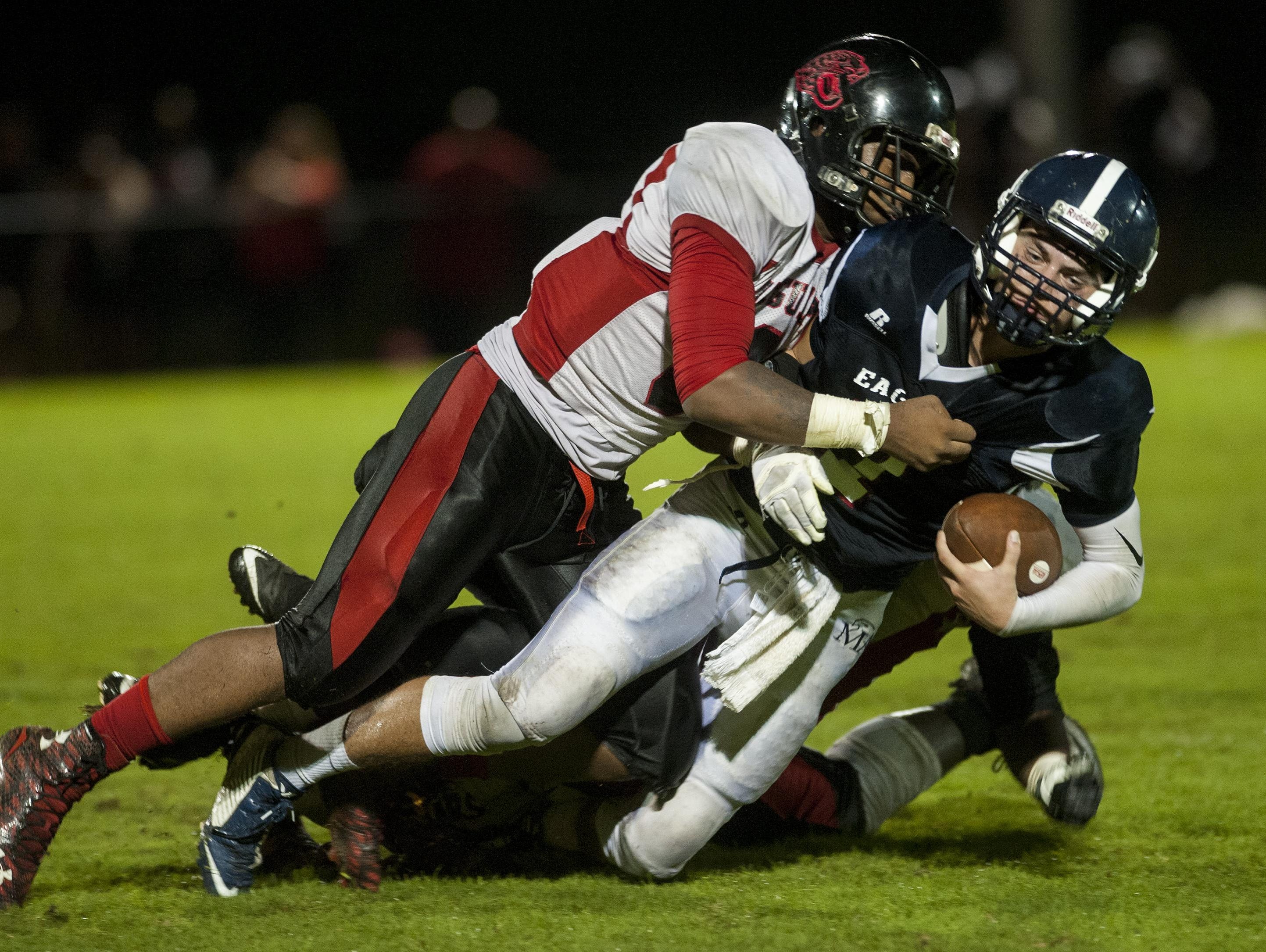 Montgomery Academy quarterback Barton Lester is sacked by Hillcrest defender Rajos Smith at the MA campus in Montgomery, Ala. on Friday November 6, 2015.