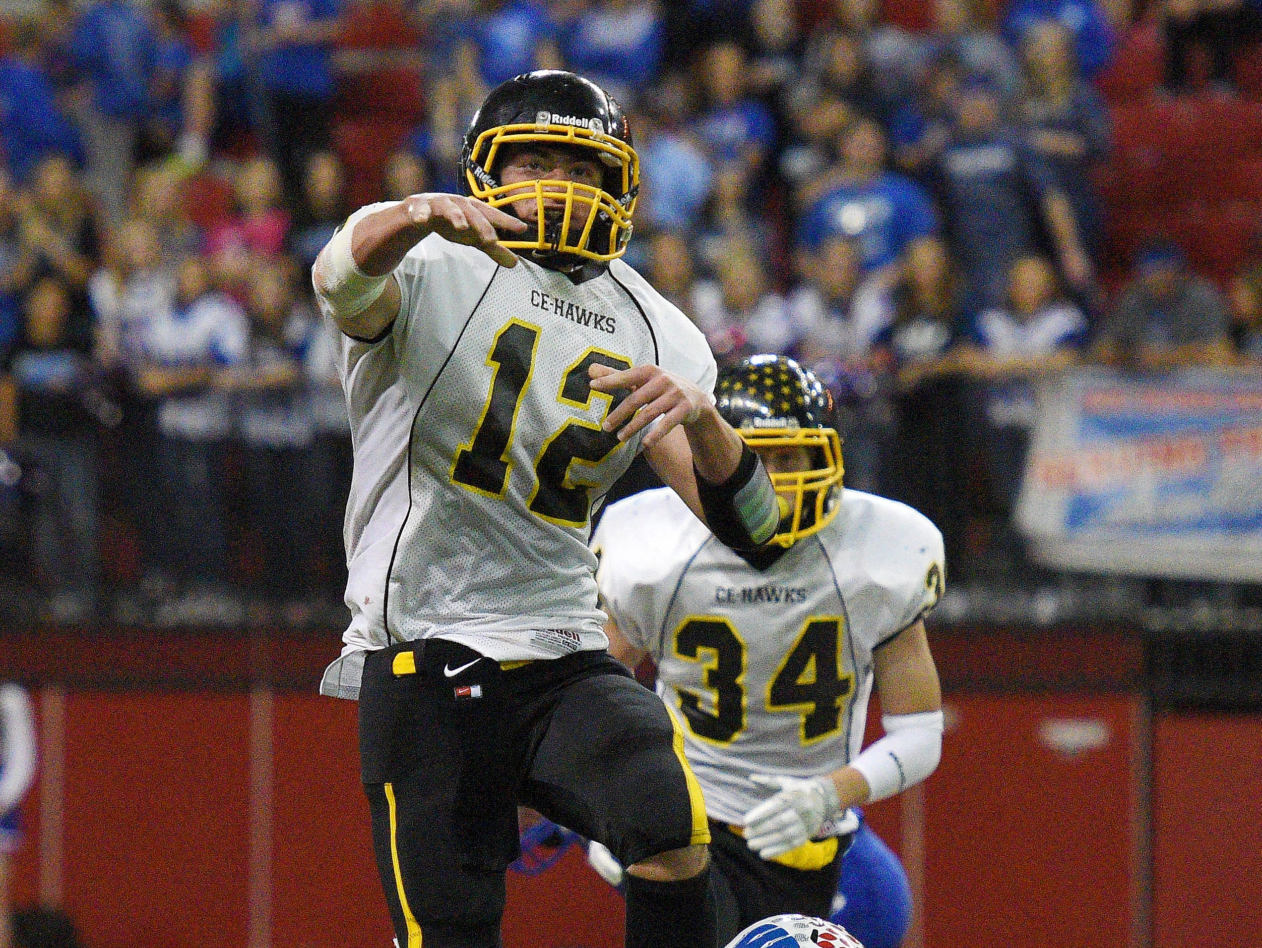 Colman-Egan's Bodee Groos throws a pass while trying to escape from Warner's Daylin Simon during the South Dakota Class 9A High School football championship on Thursday at the DakotaDome in Vermillion.