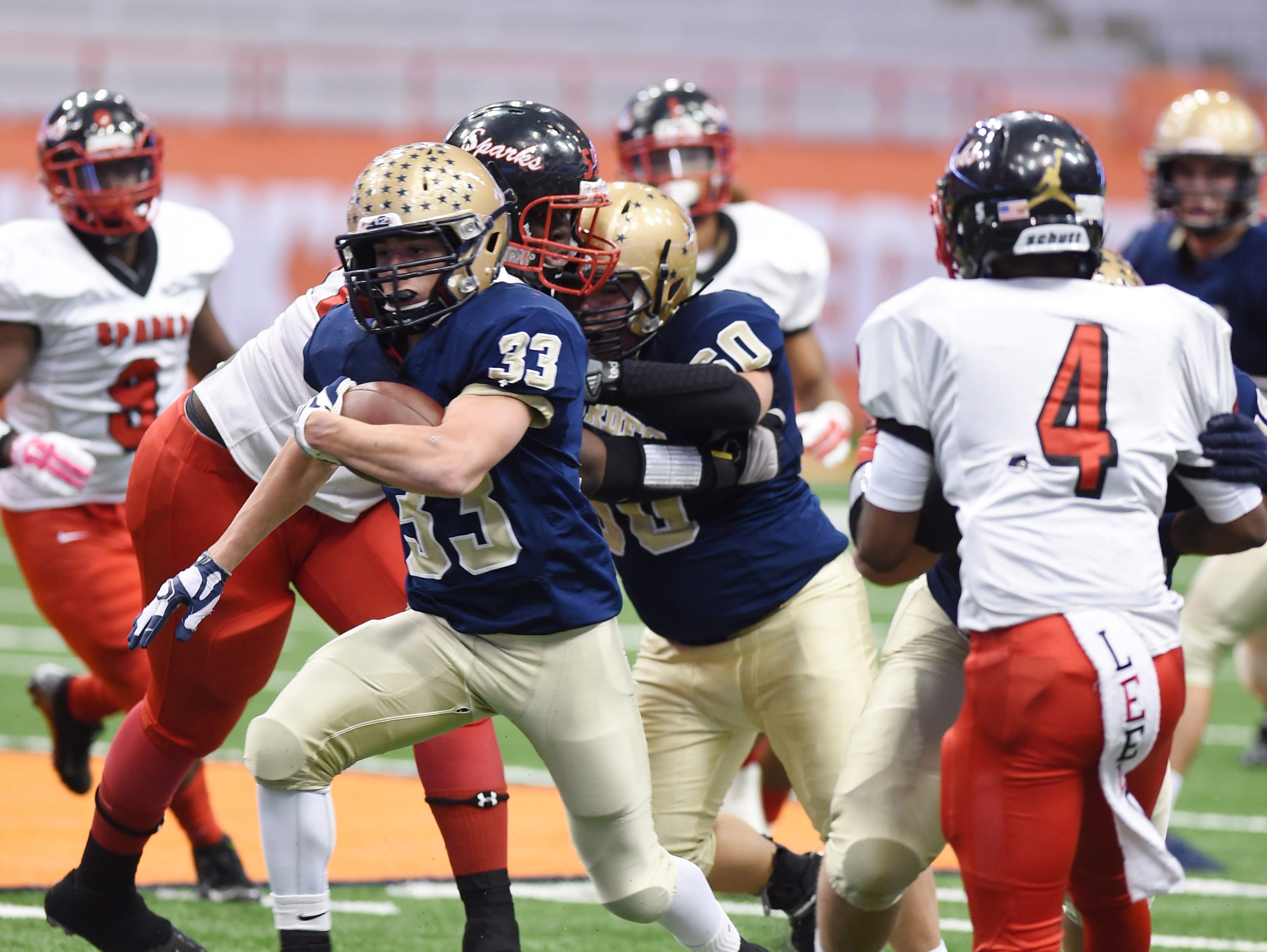 Our Lady of Lourdes High School's Joe Scaglione carries the ball through the South Park defense during the Class A New York State championship in Syracuse on Nov. 27, 2015.
