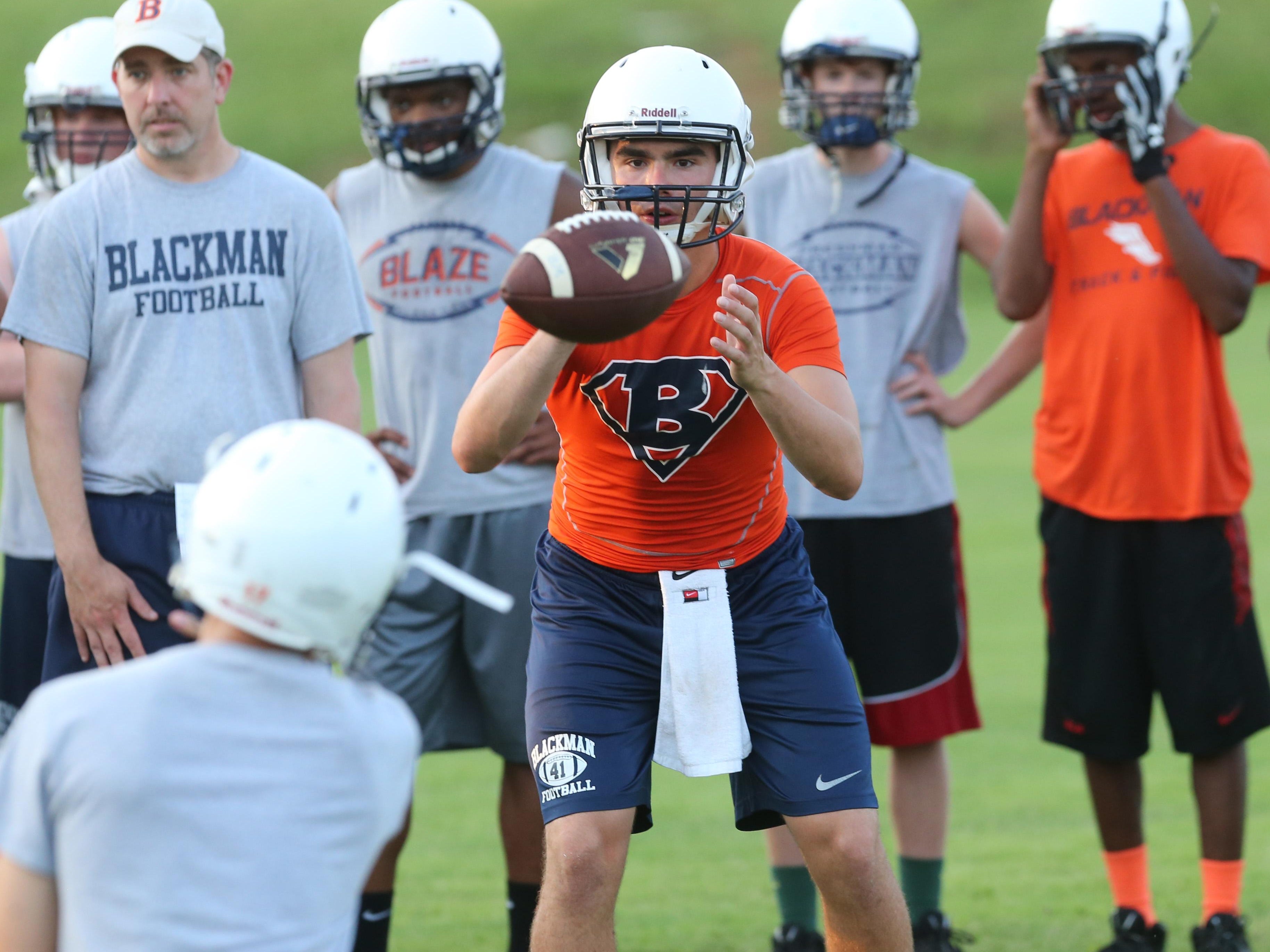Blackman quarterback Miller Armstrong takes a snap during Monday’s practice. Armstrong replaces Jauan Jennings at quarterback.