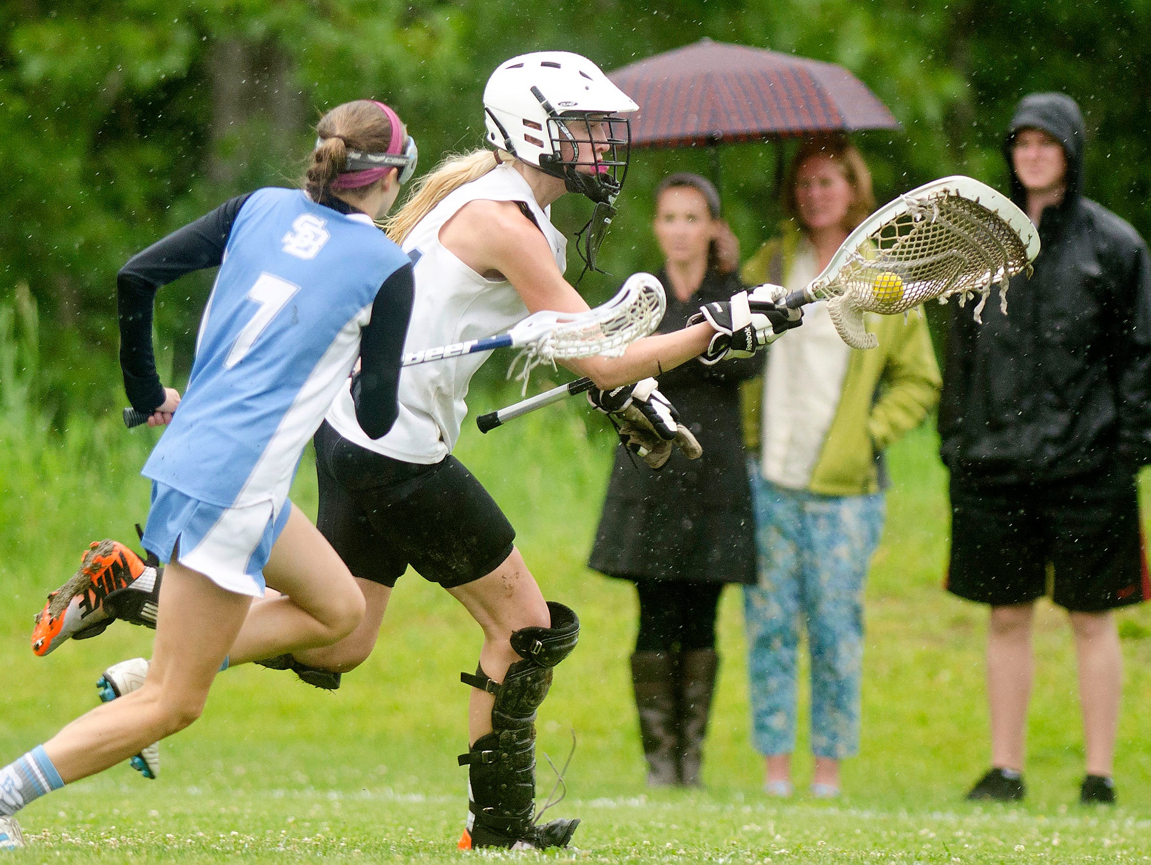 Mount Mansfield goalkeeper Colby Knight, right, races out of her crease with the ball during the second half of last year’s girls lacrosse semifinal against South Burlington in Jericho.