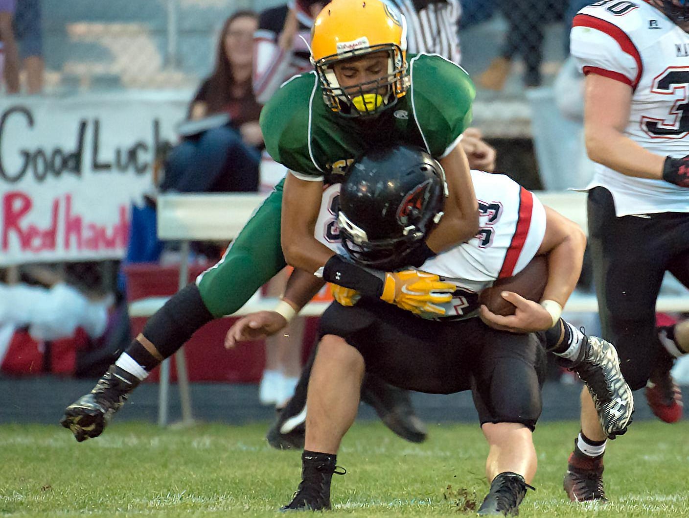 Panthers Domonick Gibson (12) has an open field tackle on Marshall's RB Christ Upright (33) Friday night.