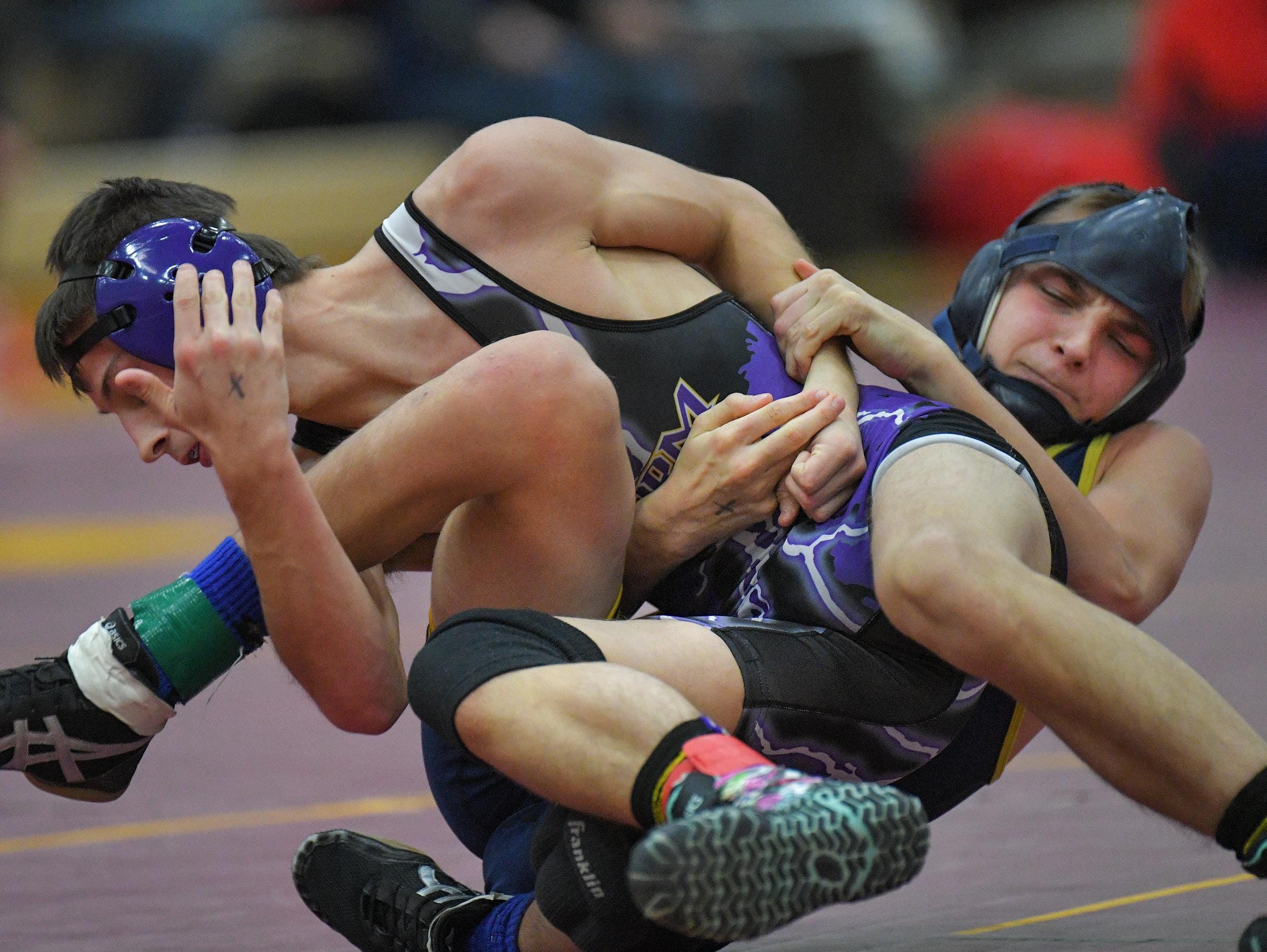 Trent Breckheimer of Chilton/Hilbert, right, wrestles Cam Knop of Kewaunee on Saturday at the Omro Invitational.
