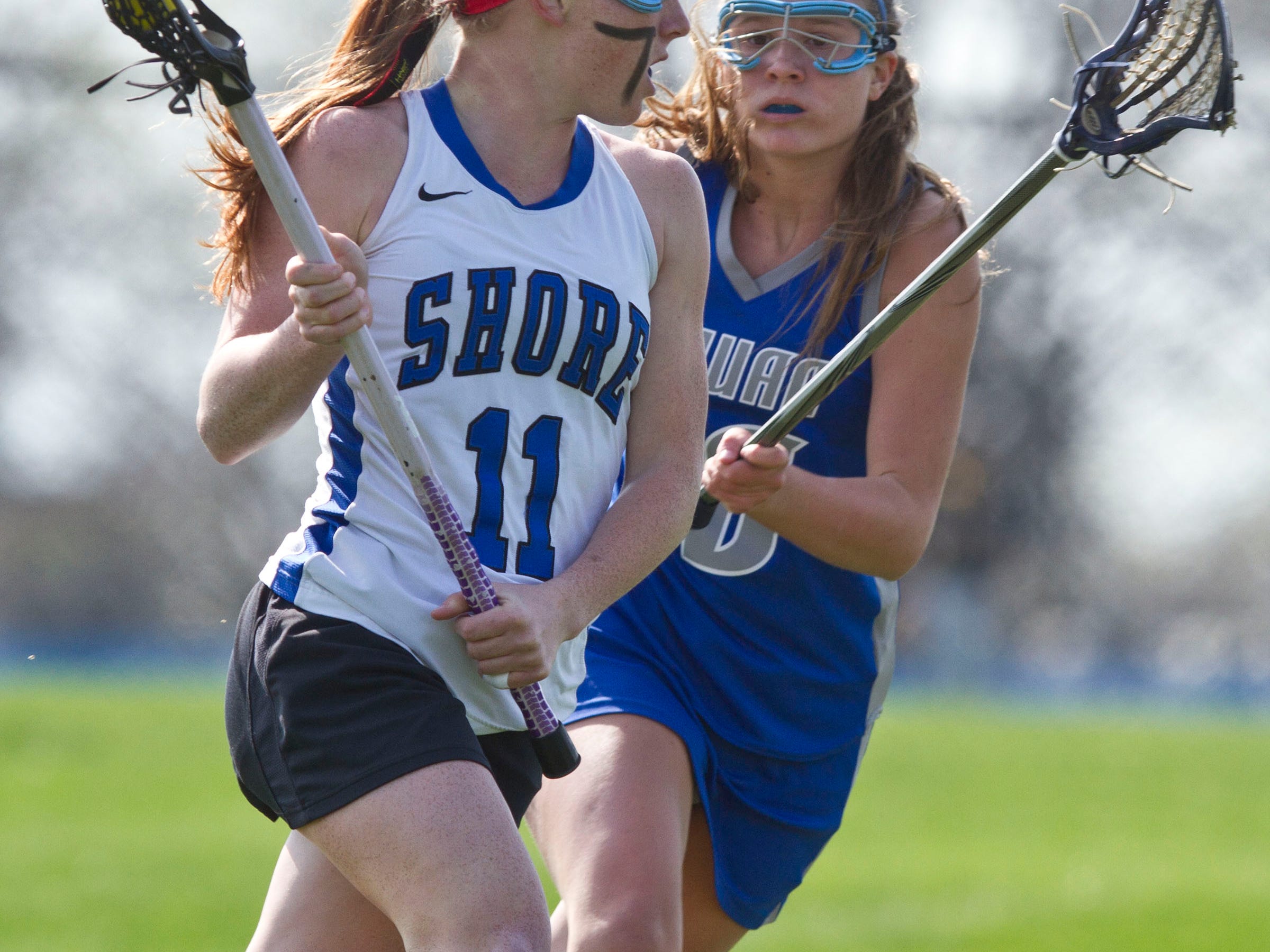 Shore Regional's Mary Kate George moves up the field past Manasquan's Haleigh McGowan. Manasquan vs Shore Regional lacrosse. West Long Branch, NJ Tuesday, April 21, 2015 Doug Hood/Staff Photographer @dhoodhood
