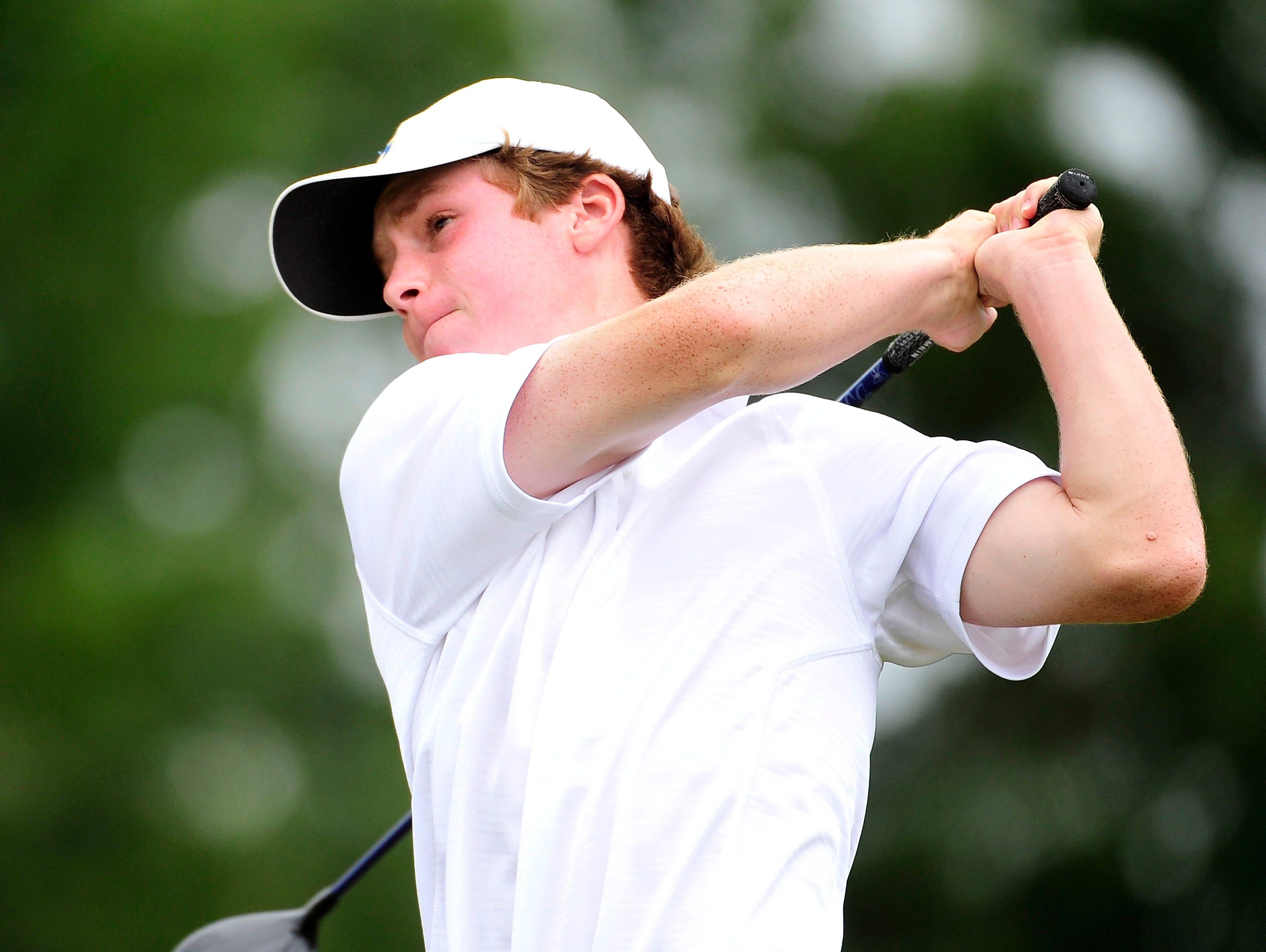 Brentwood's Eli Charron watches his tee shot on the ninth hole during the Class AAA Golf Tournament at WillowBrook Golf Club in Manchester on Sept. 30, 2015.