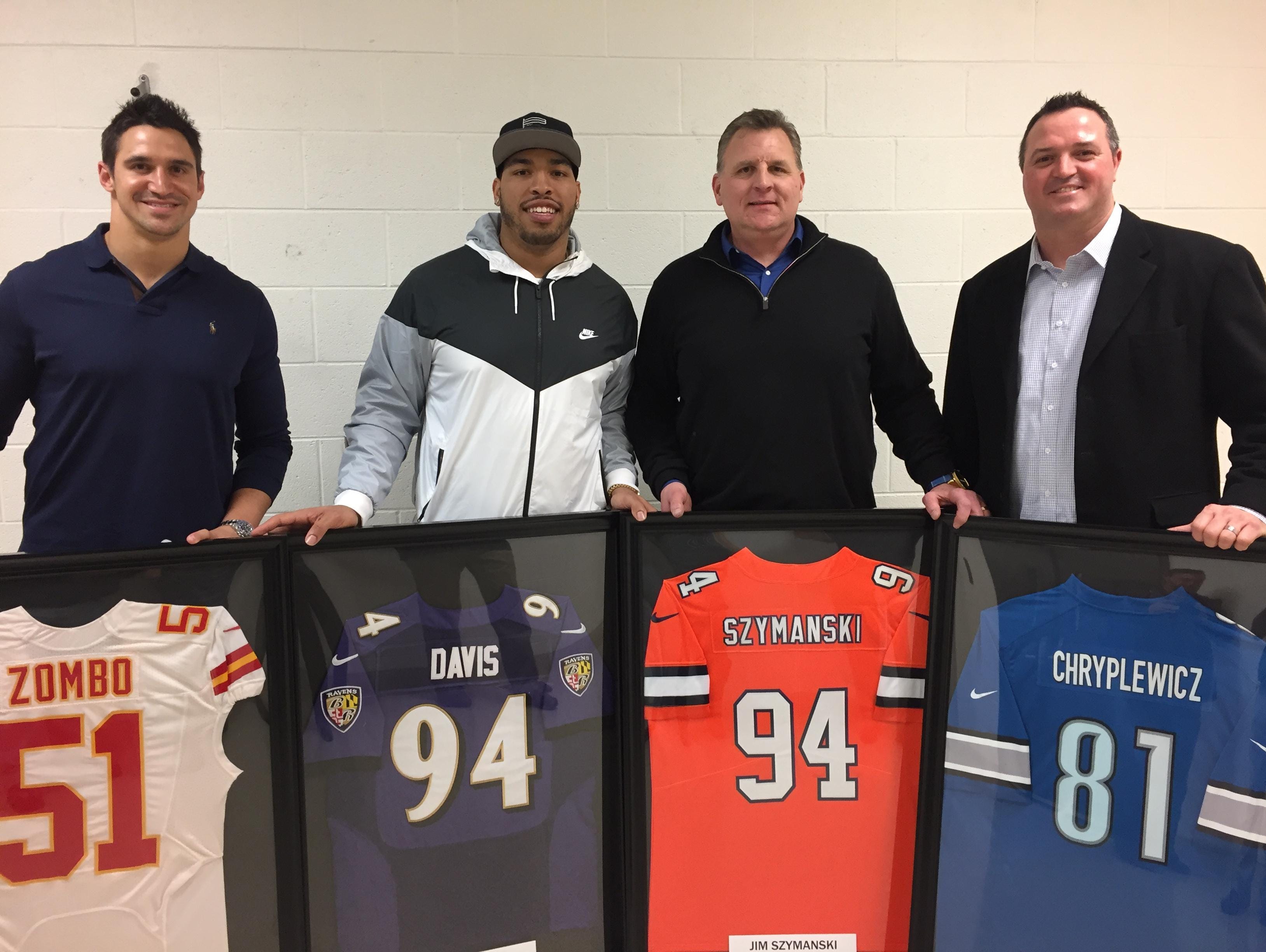 Former Sterling Heights Stevenson and NFL players, from left, Frank Zombo, Carl Davis, Jim Szymanski and Pete Chryplewicz were honored with a jersey ceremony Thursday, Jan. 26, 2017 at their former high school.
