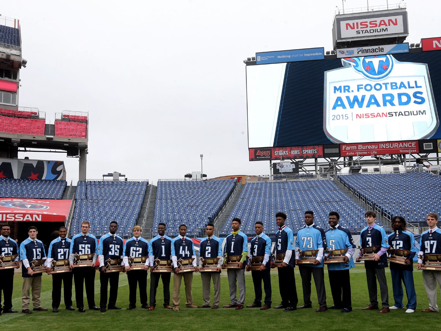 The 2015 Tennesseee Titatns Mr. Football Award winners on the Nissan Stadium Titans football field gather for a photograph in their own personalized Titans jerseys.