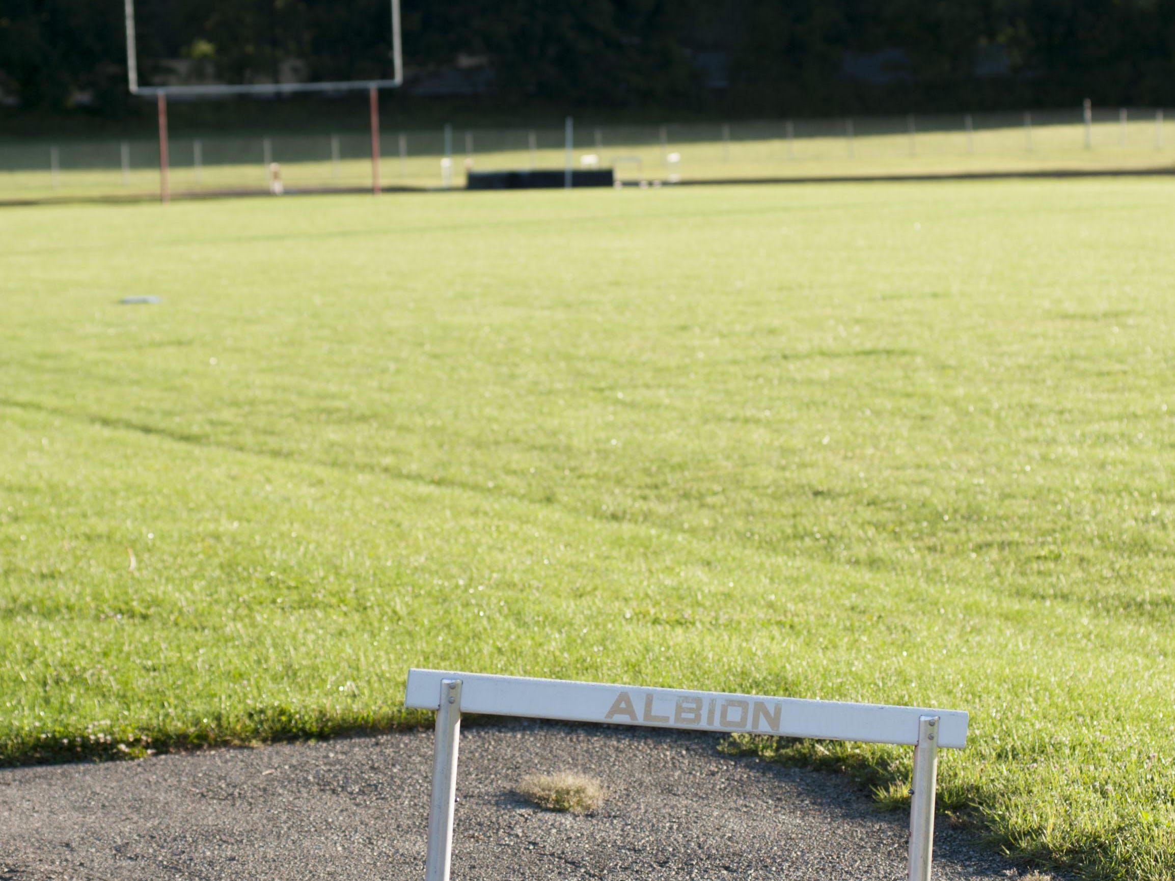 Albion High School’s football field sits empty after the school closed its doors in 2013.
