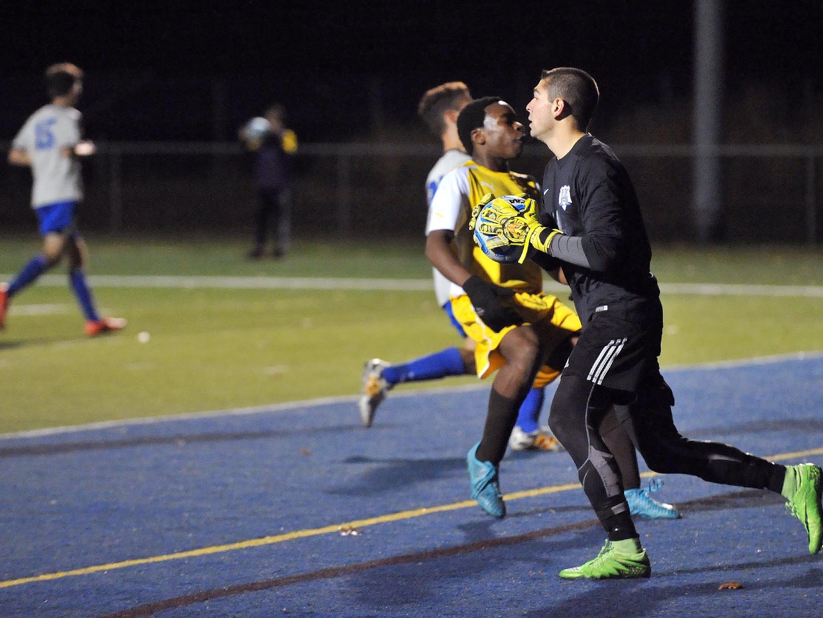 Holmdel goalkeeper Tyler Marchiano (right) makes a save against Delran in their Group 2 boys' soccer semifinal, Tuesday, Nov. 17 in Buena Vista.