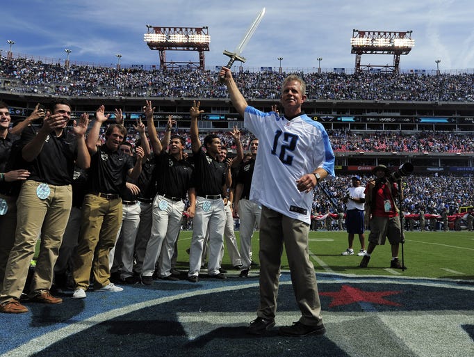 Vanderbilt baseball coach Tim Corbin holds up the sword as he and his baseball team were part of the opening ceremonies before the Titans game against the Cowboys at LP Field Sunday Sept. 14, 2014, in Nashville, Tenn.
