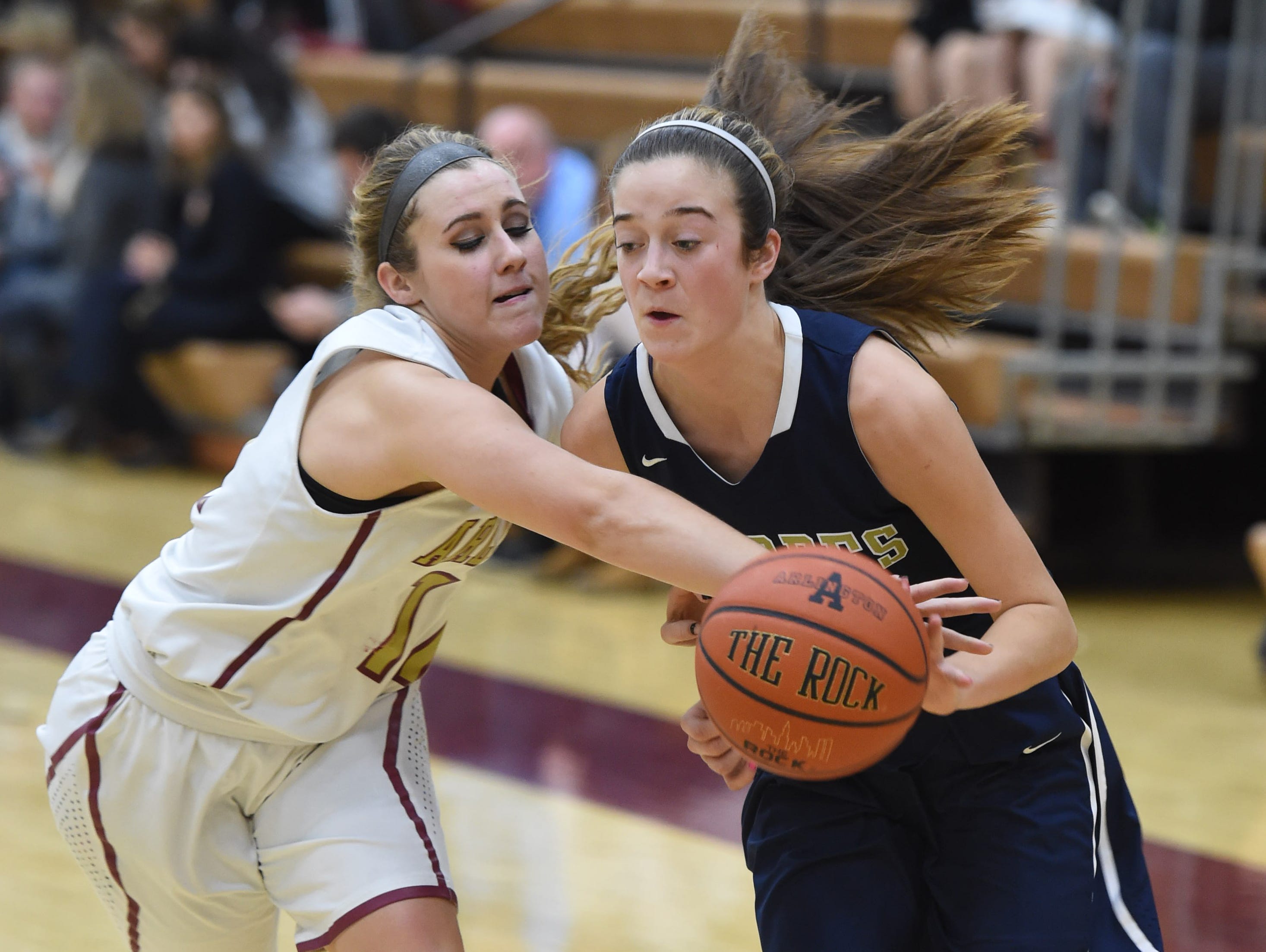 Arlington's Cassidy Clay slaps the ball away from Lourdes' Madison Siegrist during Wednesday's game at Arlington.