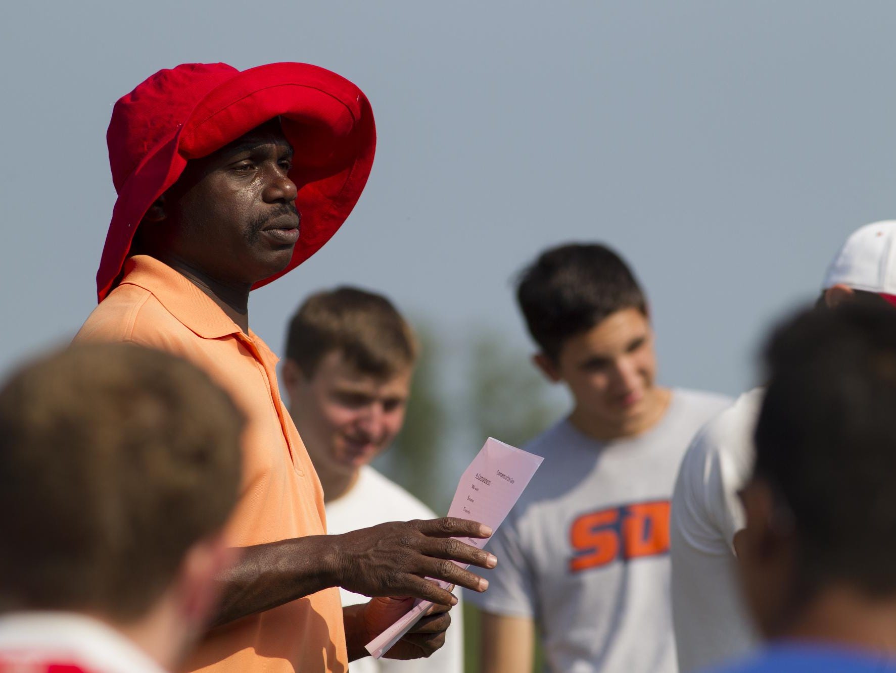 Coach Gilbert Antoine shares some of his philosophy and methods with the Ithaca High varsity boys soccer team Monday morning, the first day of practice for fall sports.