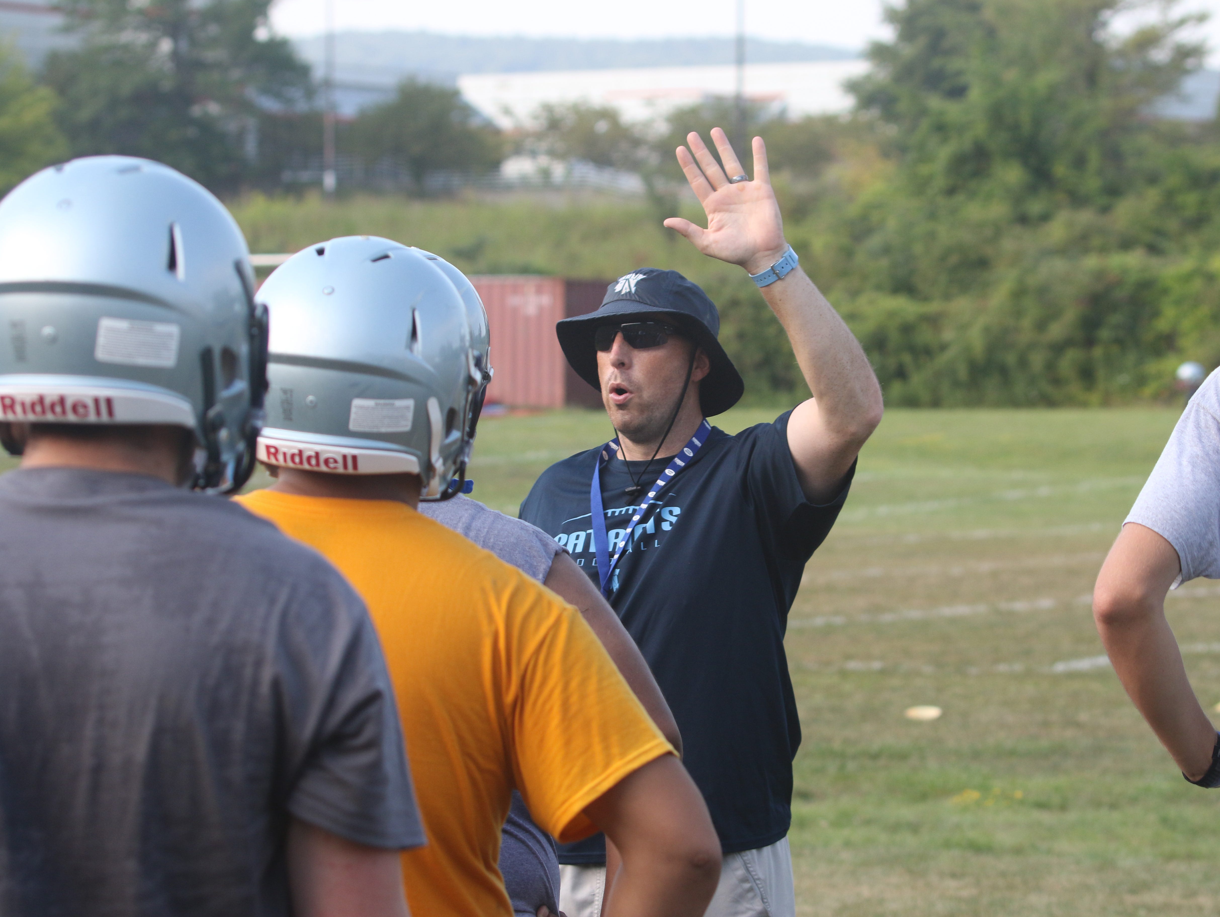 John Jay High School football coach Tom O'Hare gives instructions to players during practice on Wednesday.