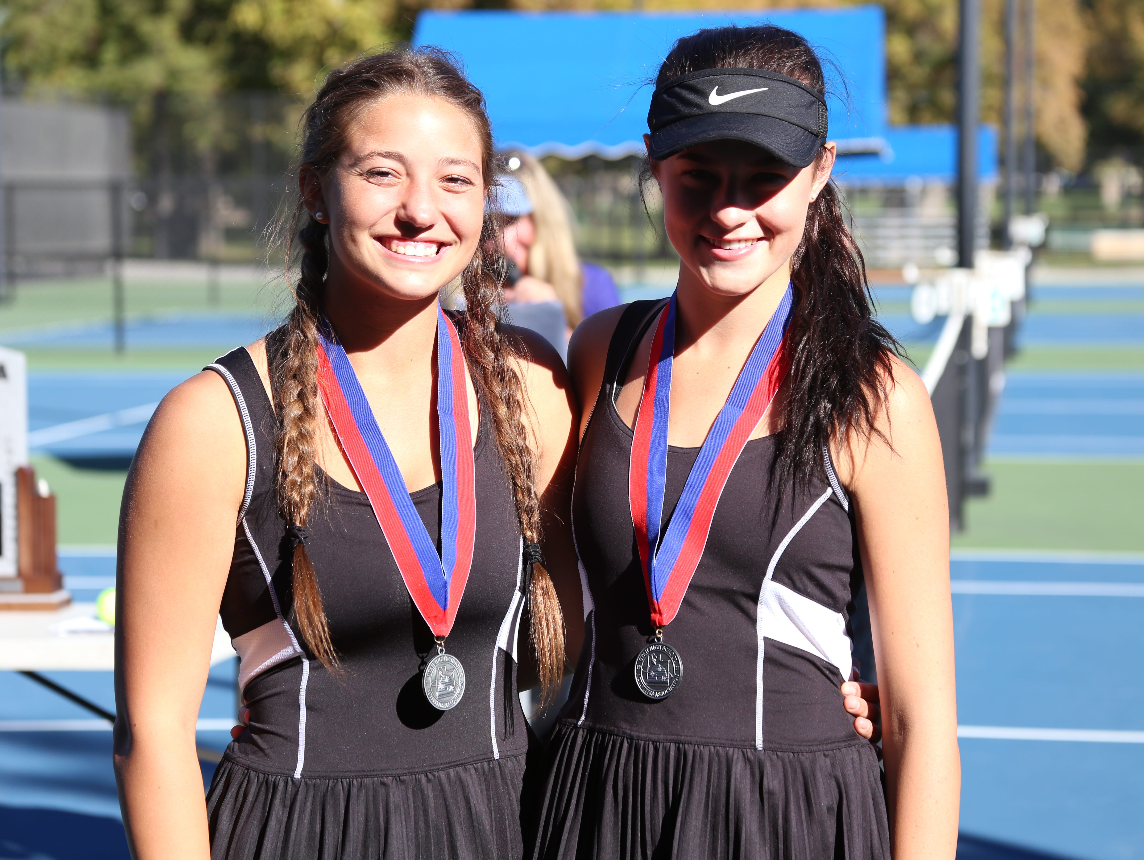 Desert Hills' Alani Plumb and Allie Beck pose for a picture after taking second in first doubles at the 2016 3A state tournament at Liberty Park on Friday.