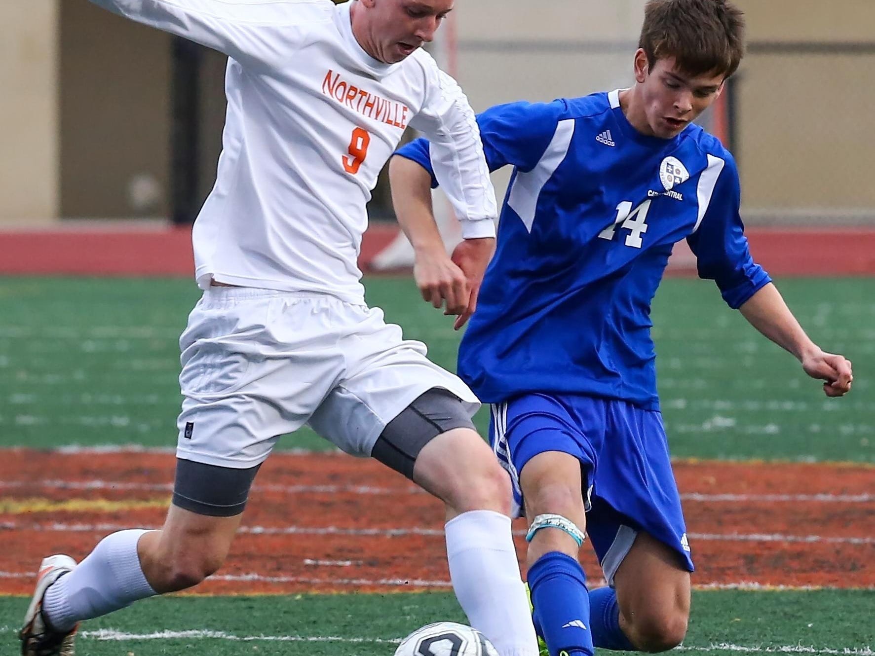 Northville defender Garret Weaver (left), taking on Catholic Central’s Noah Walter, was named boys soccer All-Area Player of the Year.