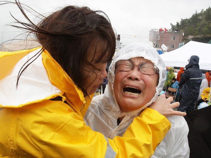 A relative of a missing passenger weeps as she waits at the port on Jindo Island.