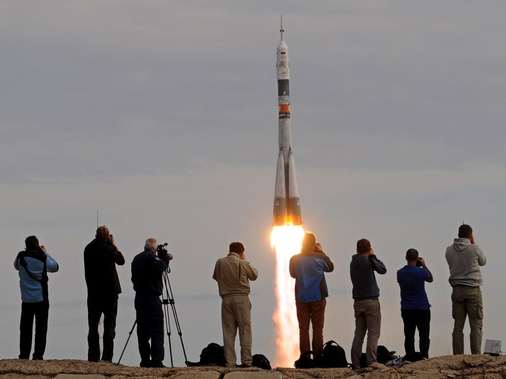 Russia's Soyuz TMA-18M spacecraft, carrying the International Space Station crew of Kazakh cosmonaut Aydyn Aimbetov, Russian cosmonaut Sergei Volkov and Danish astronaut Andreas Mogensen from the European Space Agency, blasts off from the launch pad 