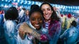 Simone Biles and Aly Raisman wear ponchos at the heroes