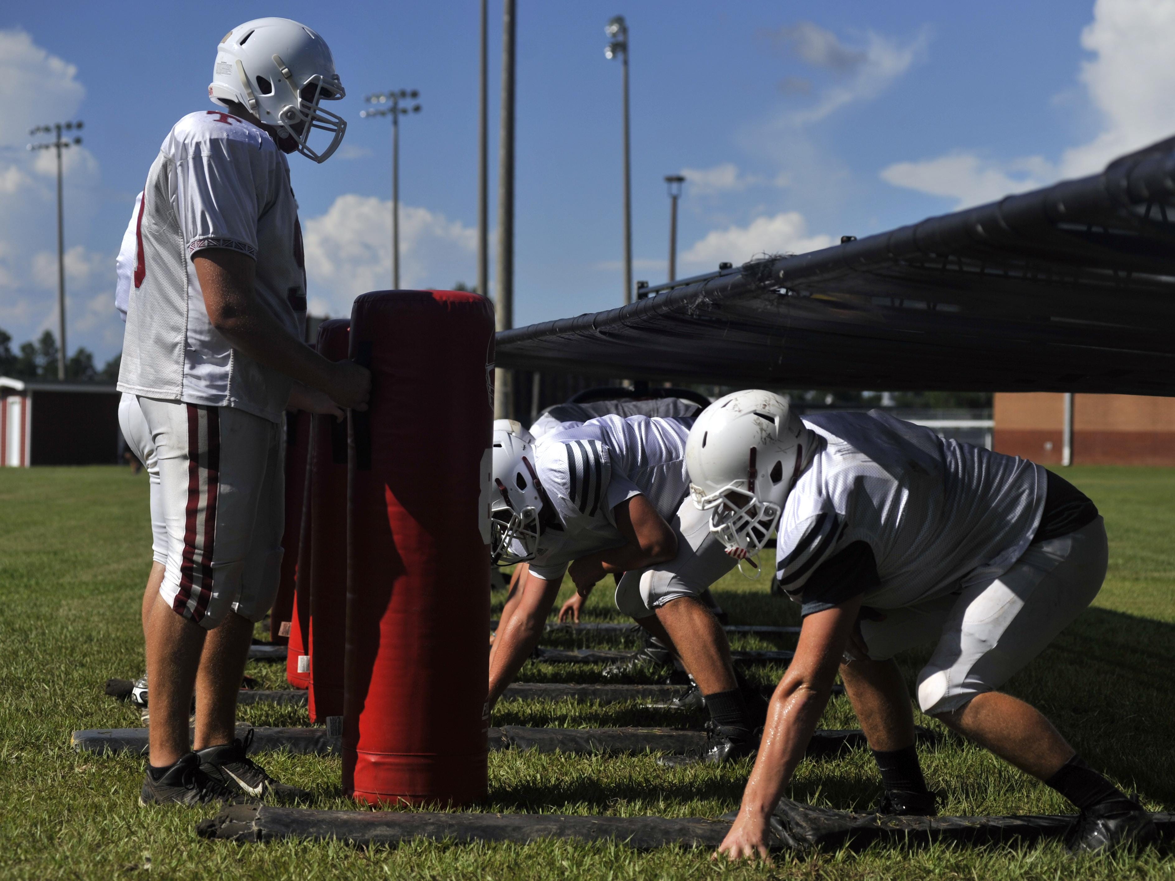 The Tate Aggies line up to run drills during practice on Aug. 16, 2016.