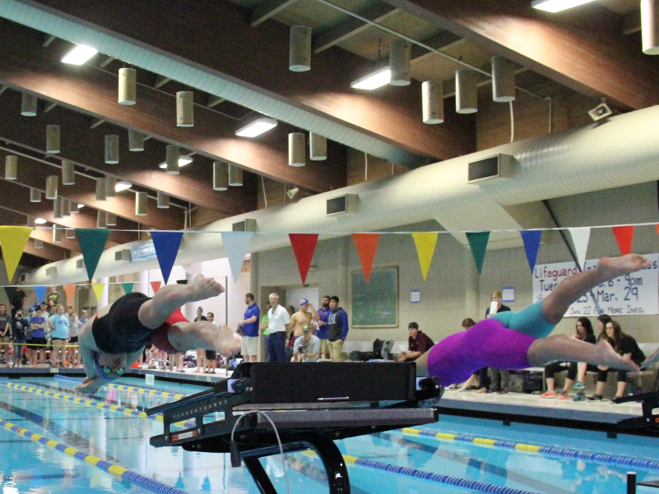 South Salem's Anna Despain (left) and West Salem's Hannah Bodkin start the 200 individual medley, which Despain won, at the Greater Valley Conference district swimming meet at McMinnville Aquatic Center on Saturday, Feb. 13, 2016.