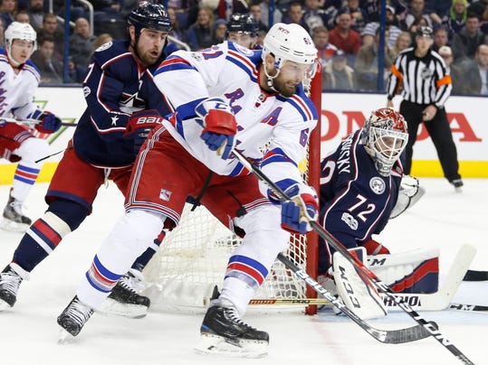 New York Rangers' Rick Nash, center, takes a shot against Columbus Blue Jackets' Sergei Bobrovsky, right, of Russia, as Brandon Dubinsky defends during the third period of an NHL hockey game Monday, Feb. 13, 2017, in Columbus, Ohio. The Rangers beat the Blue Jackets 3-2. (AP Photo/Jay LaPrete)