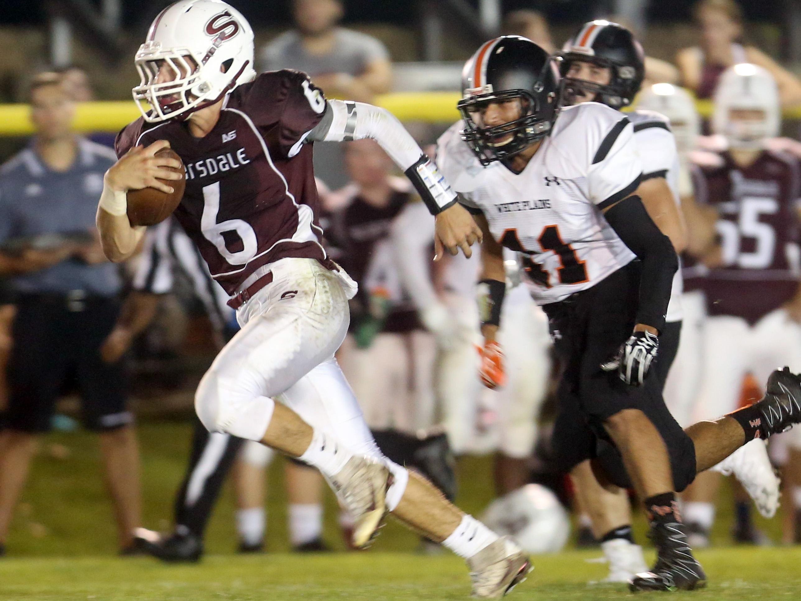 Scarsdale quarterback Barry Klein breaks free for a 40-yard touchdown run against White Plains during Friday night’s game at Scarsdale High School.