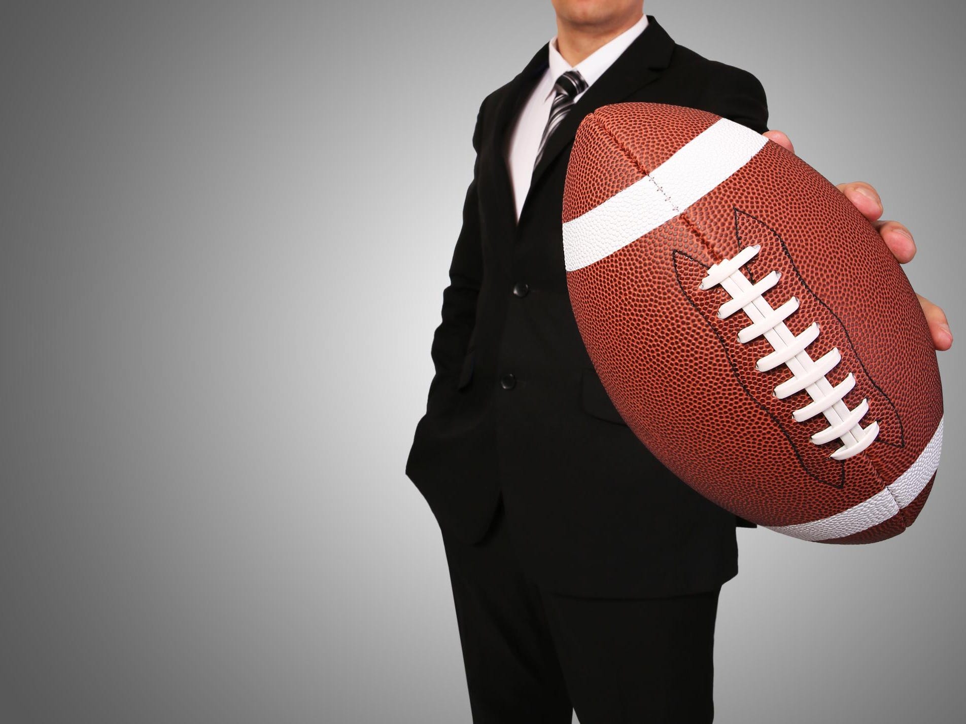 Businessman with American Football Ball