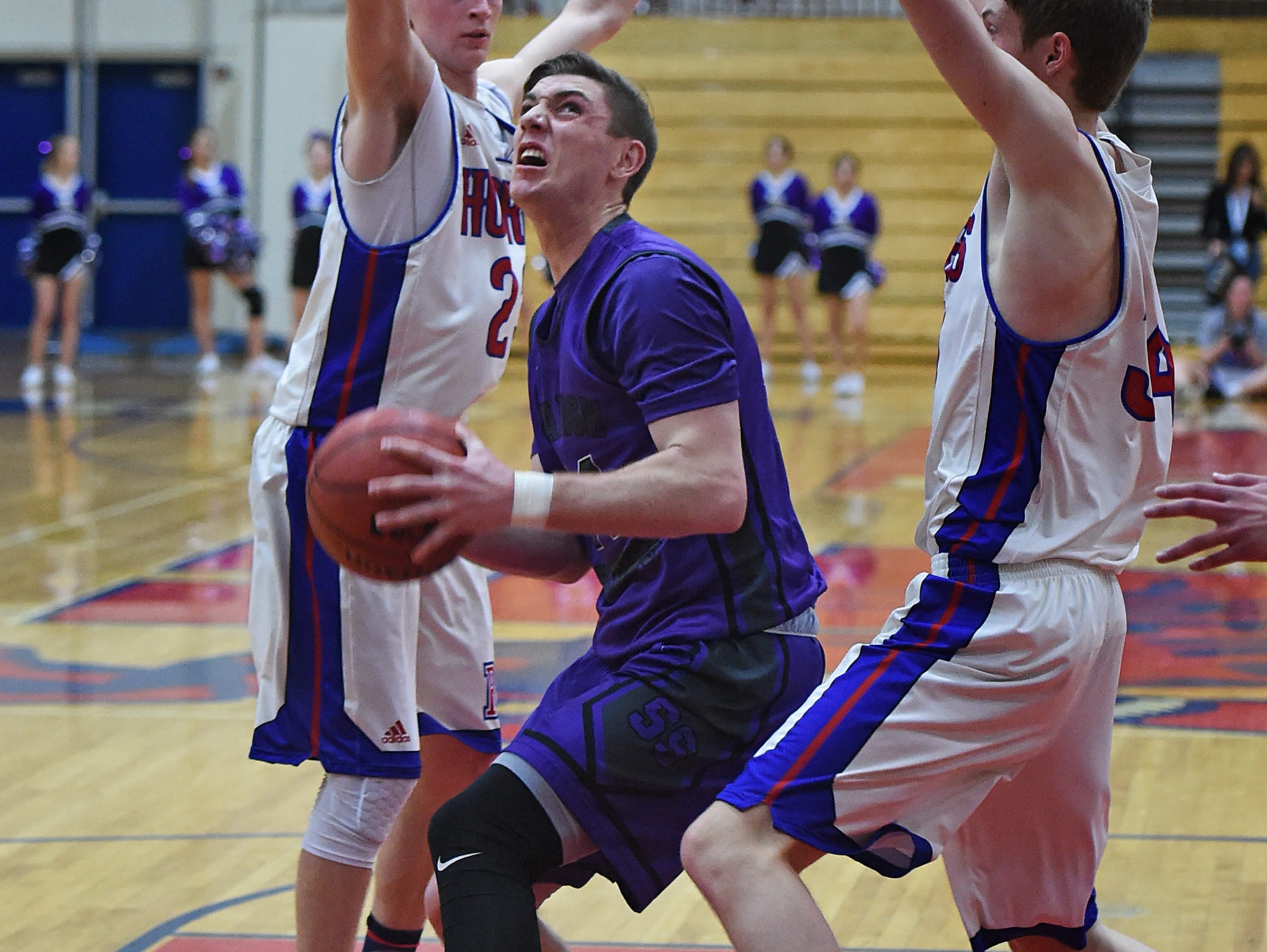 Spanish Springs' Josh Prizina looks to shoot with Reno's Drew Rippingham, left, and Tommy Challis guarding on Feb. 7. Przina and the Cougars are looking for their first Regional title.