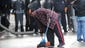 A man cleans up a street during a protest in Baltimore.