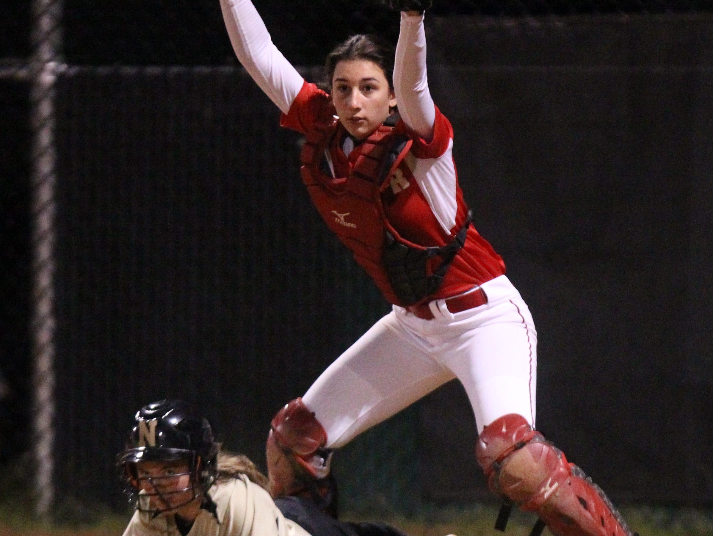 North Rockland catcher Bella Chiorazzi shows the ball after making a tag at the plate against Nanuet.