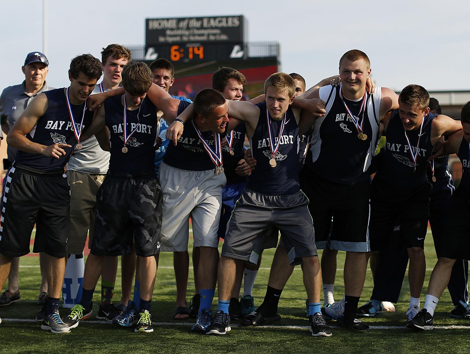 Bay Port track and field teammates huddle up before receiving the championship trophy for winning the Division 1 team title.