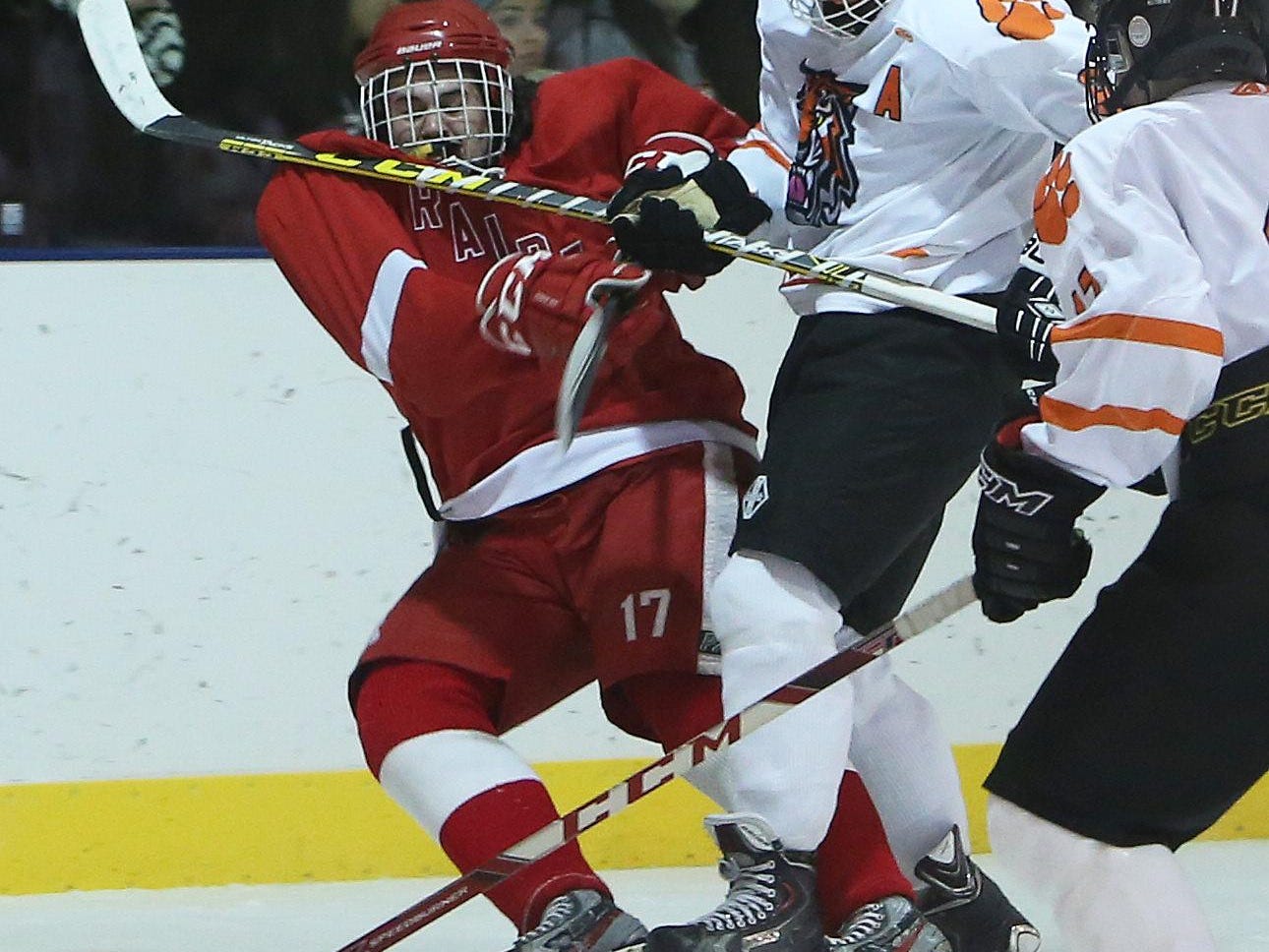 From left, North Rockland's Charles Lowther (17) and White Plains' James Carrier (8) battle for puck control during hockey action at Ebersole Ice Rink in White Plains Jan. 7, 2016. The game ended in a 4-4 tie.